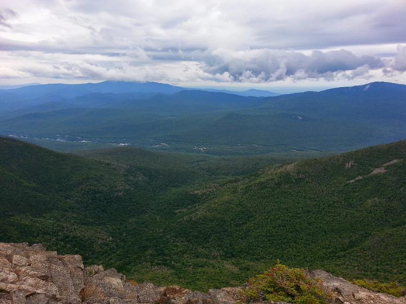 20140816_124725.jpg - Another view into the valley. Mt. Moosilauke is in the clouds and the Kinsmans are to the right.
